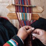 A woman at the Chinchero Weaving Collective creating a meticulous pattern