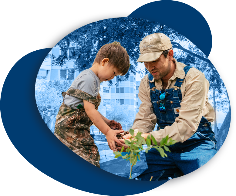 Veteran planting a plant with child