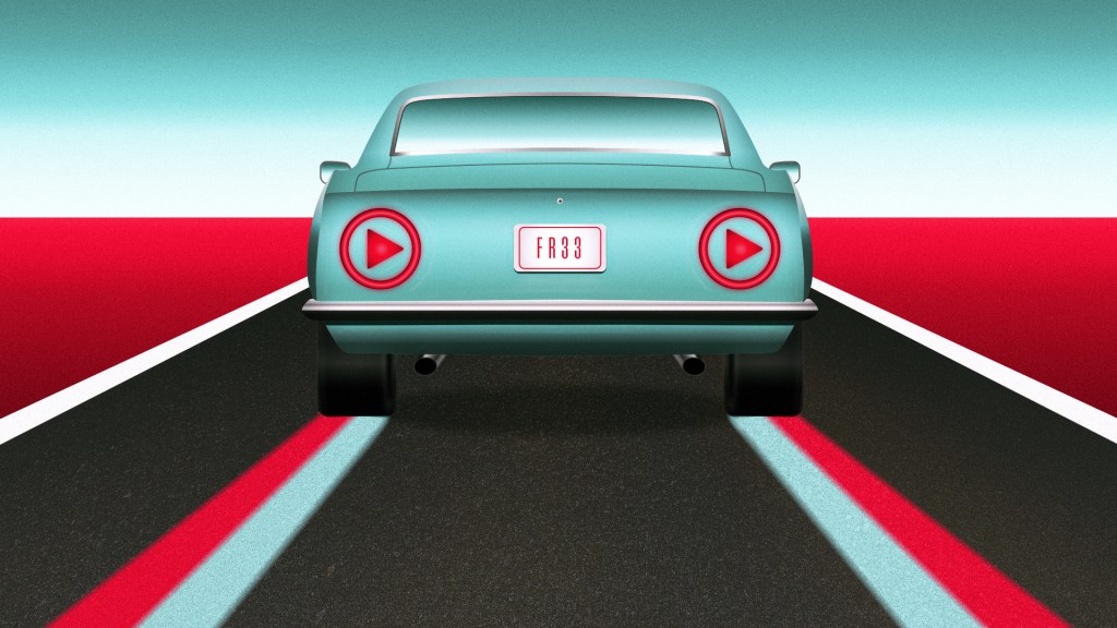 A car with play button taillights driving down a road