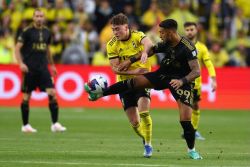 COLUMBUS, OHIO - DECEMBER 09: Denis Bouanga #99 of Los Angeles FC controls the ball while defended by Aidan Morris #8 of Columbus Crew during the first half during the 2023 MLS Cup at Lower.com Field on December 09, 2023 in Columbus, Ohio. (Photo by Maddie Meyer/Getty Images)