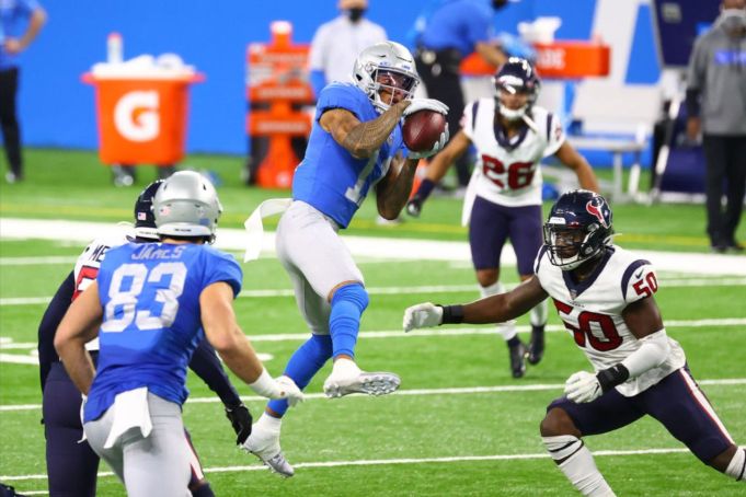 DETROIT, MI - NOVEMBER 26: Marvin Jones #11 of the Detroit Lions makes a catch in front of Tyrell Adams #50 of the Houston Texans at Ford Field on November 26, 2020 in Detroit, Michigan. (Photo by Rey Del Rio/Getty Images)