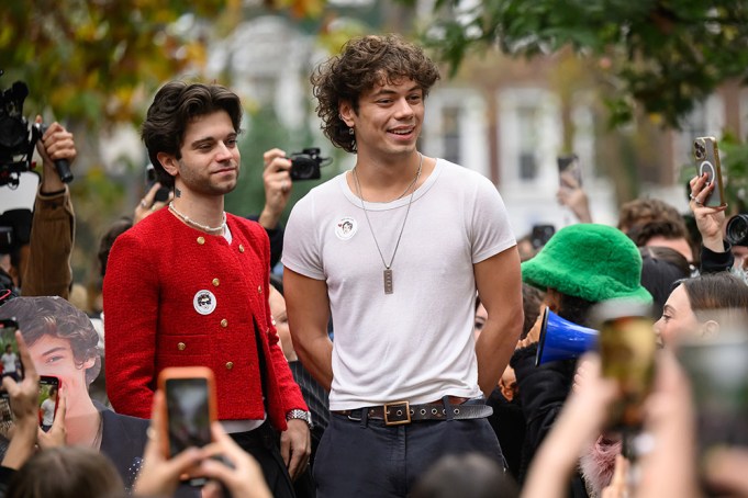 LONDON, ENGLAND - NOVEMBER 09: Runner-up Mitch (L) and Oscar, the winning contestant in a Harry Styles lookalike competition, are cheered by fans of the former One Direction singer after the winner is announced at Soho Square on November 09, 2024 in London, England. After a Timothee Chalamet lookalike contest in New York went viral after the star gatecrashed the event, similar events have occurred with a Paul Mescal contest in Dublin and today, a Harry Styles event in London's Soho Square. (Photo by Leon Neal/Getty Images)