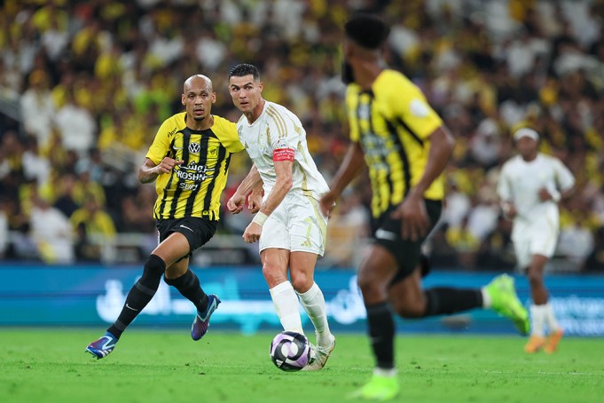 JEDDAH, SAUDI ARABIA - DECEMBER 6: Cristiano Ronaldo of Al Nassr rchallenged by Fabinho of Al Ittihad during the Saudi Pro League match between Al-Ittihad v Al-Nassr at King Abdullah Sports City on December 6, 2024 in Jeddah, Saudi Arabia. (Photo by Yasser Bakhsh/Getty Images)