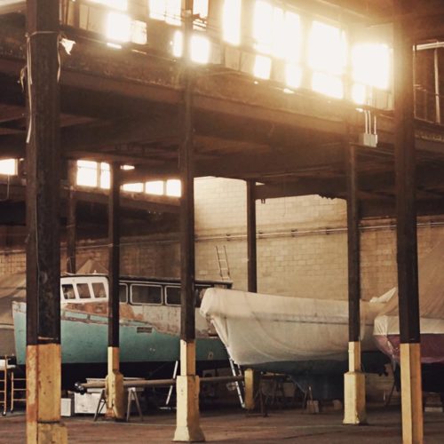 Boat being repaired in a warehouse