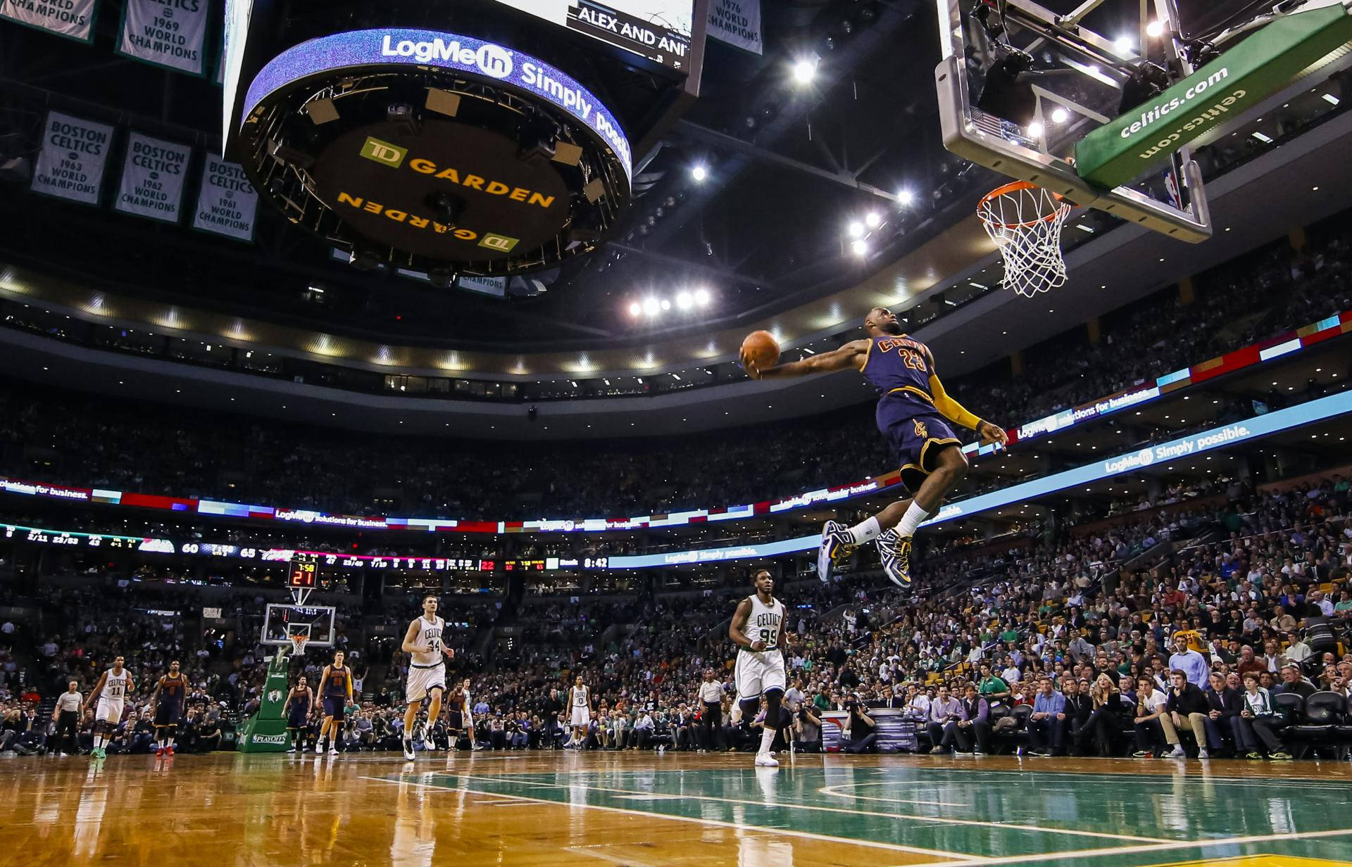 Lebron James dominating the NBA game with a slam dunk Wallpaper