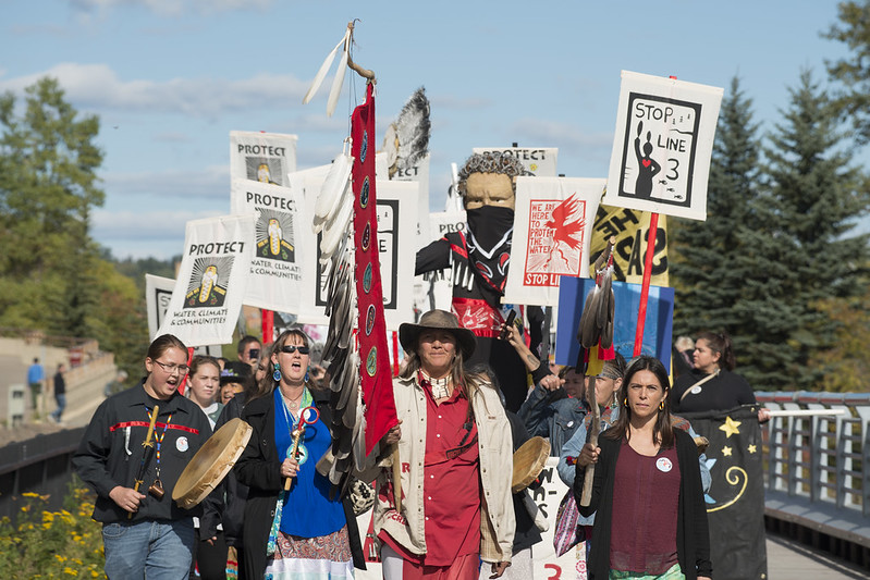 In 2019, hundreds of people gathered on the shore of Gichi-gami (Lake Superior) to protest the proposed Enbridge Line 3 tar sands pipeline. Photo by Fibonacci Blue.