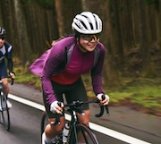 Happy woman cycling outside.