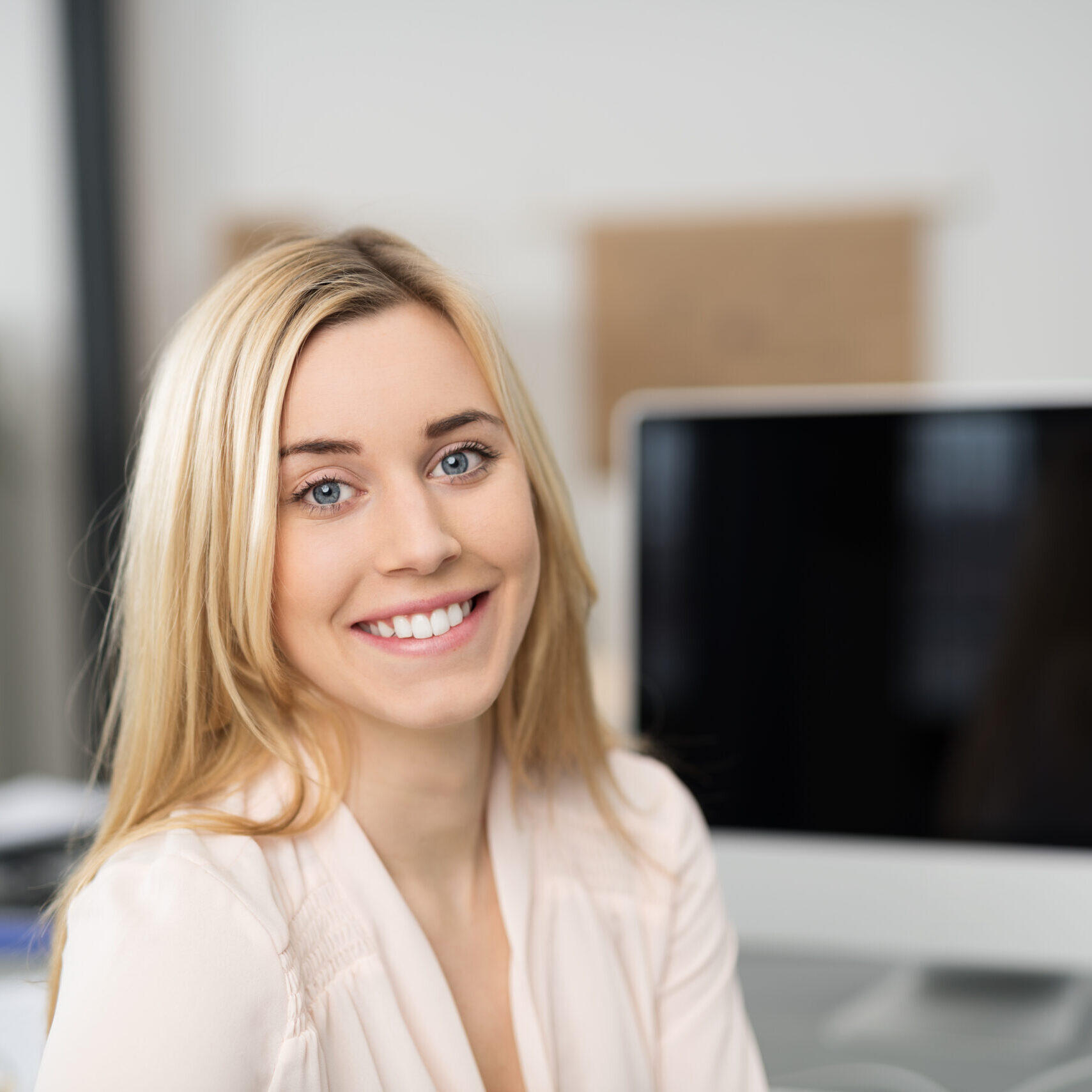 Close,Up,Optimistic,Pretty,Blond,Girl,Sitting,At,Her,Worktable