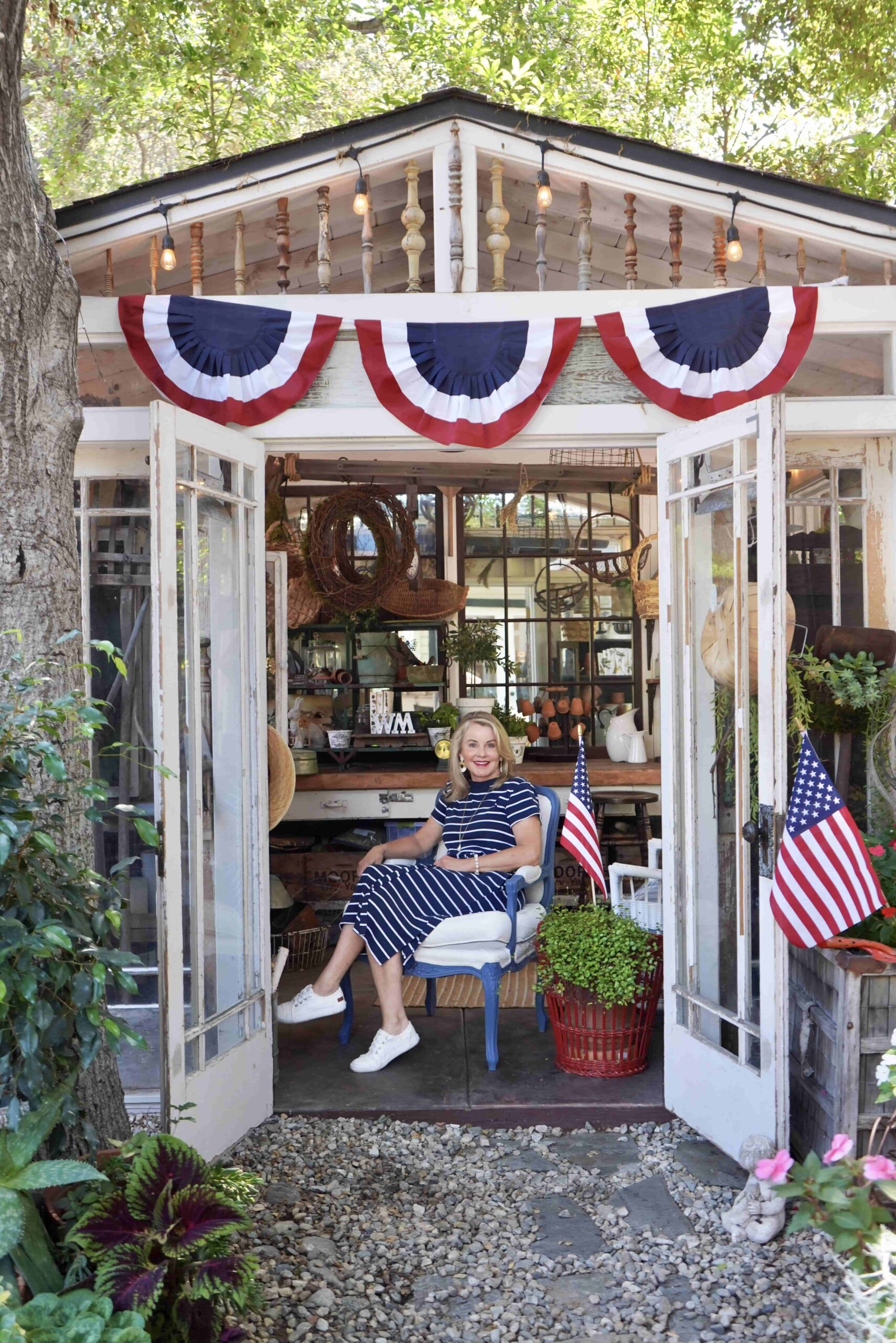 Wendy sitting on a chair inside the she shed celebrating memorial day