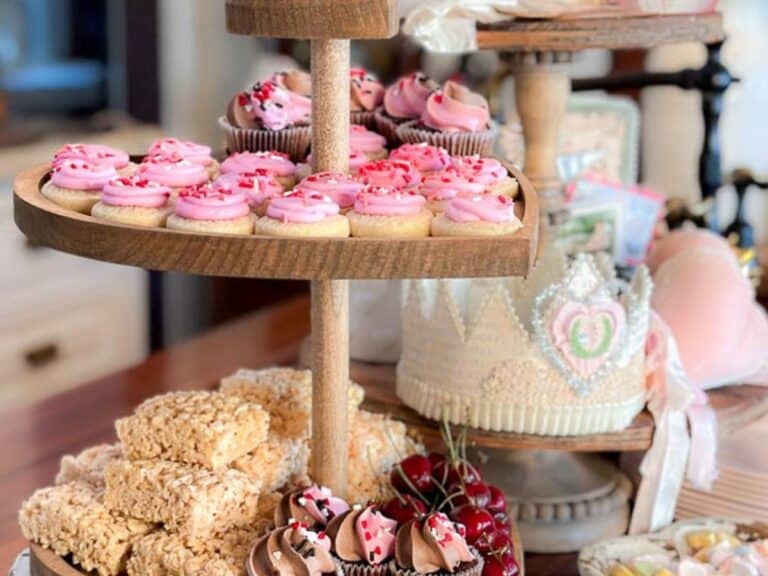 Tiered tray full of goodies for Valentine's Day. Including cookies, cupcakes and more.