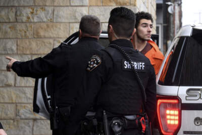 Luigi Nicholas Mangione is escorted into Blair County Courthouse, Tuesday, Dec. 10, 2024, in Hollidaysburg, Pa. (AP Photo/Gary M. Baranec)