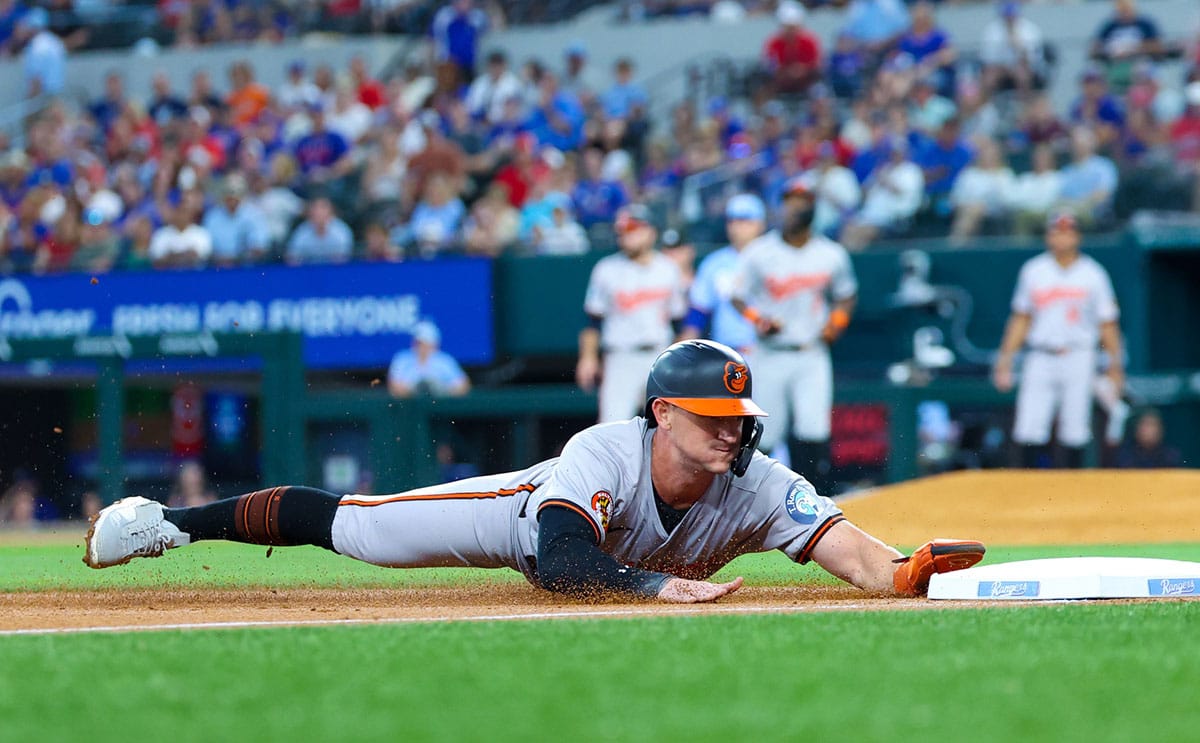 Baltimore Orioles left fielder Austin Hays (21) slides into third base during the second inning against the Texas Rangers at Globe Life Field.