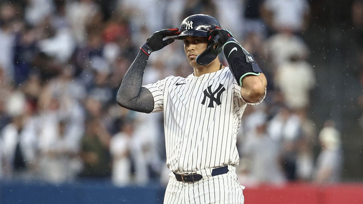 New York Yankees designated hitter Giancarlo Stanton (27) gestures after hitting a double against the Atlanta Braves in the fourth inning at Yankee Stadium