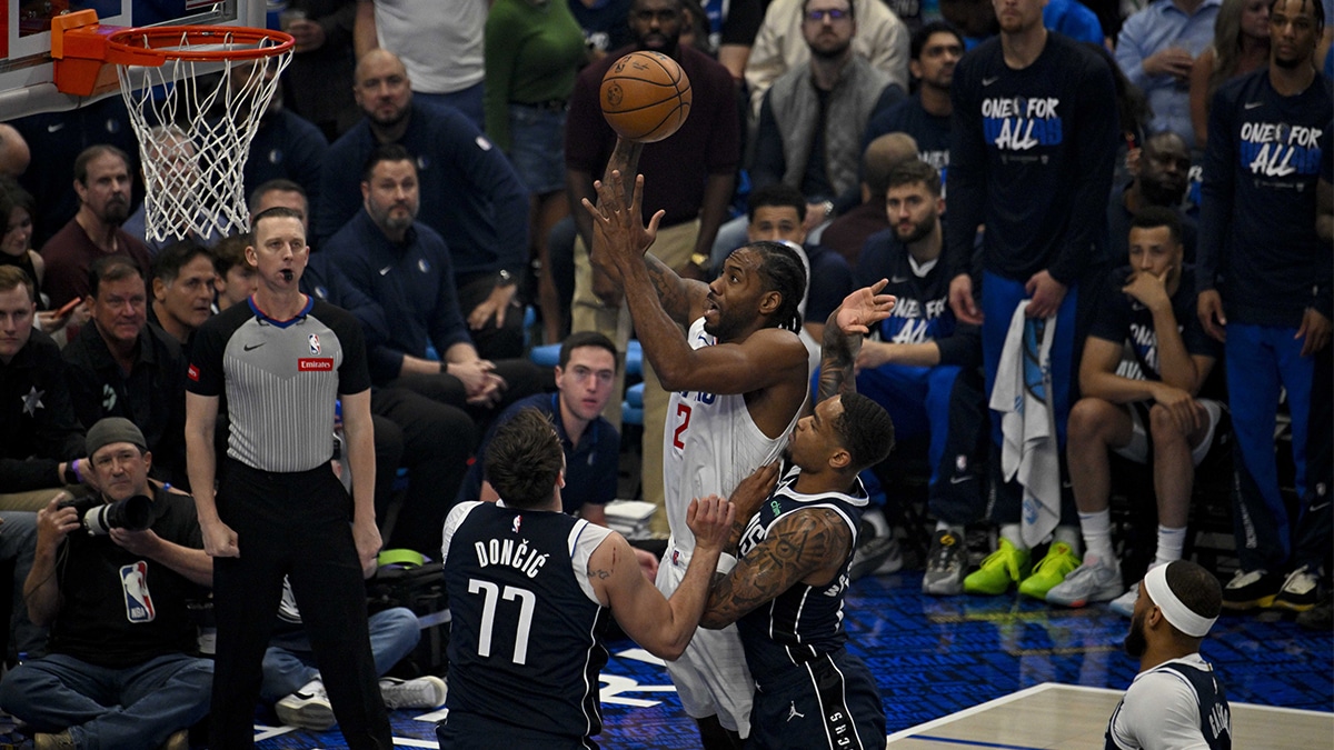 Apr 26, 2024; Dallas, Texas, USA; LA Clippers forward Kawhi Leonard (2) shoots the ball over Dallas Mavericks guard Luka Doncic (77) during the first quarter during game three of the first round for the 2024 NBA playoffs at the American Airlines Center. Mandatory Credit: Jerome Miron-USA TODAY Sports