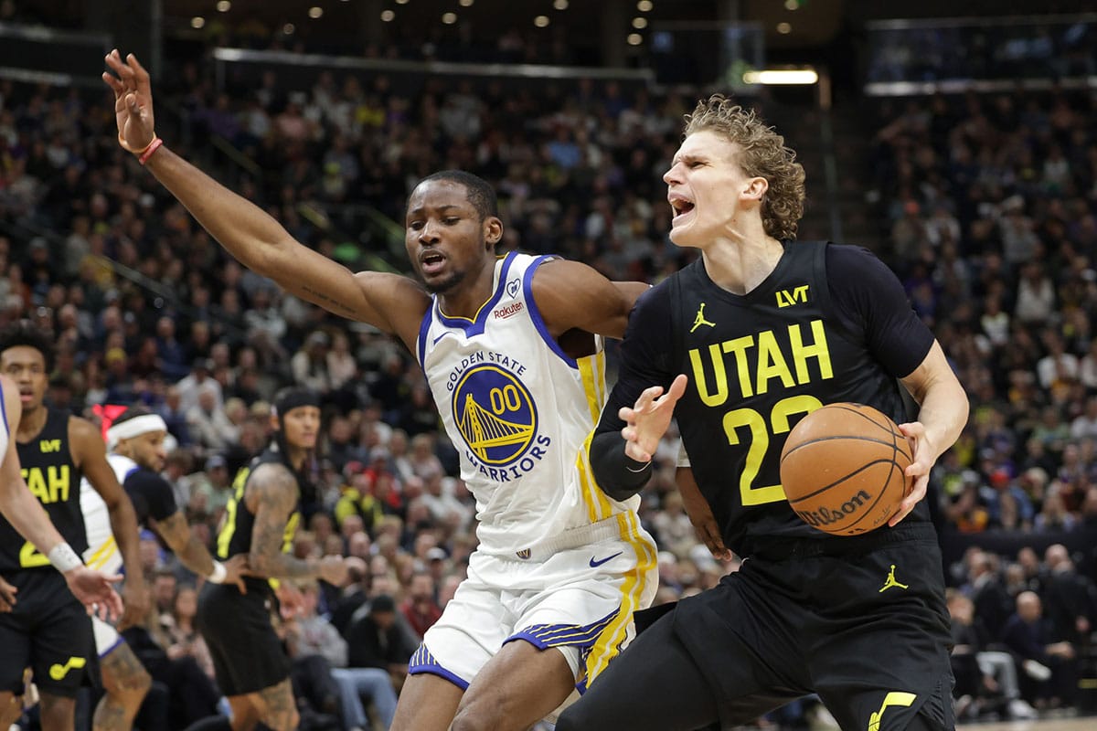 Utah Jazz forward Lauri Markkanen (23) is fouled by Golden State Warriors forward Jonathan Kuminga (00) during the second quarter at Delta Center. 