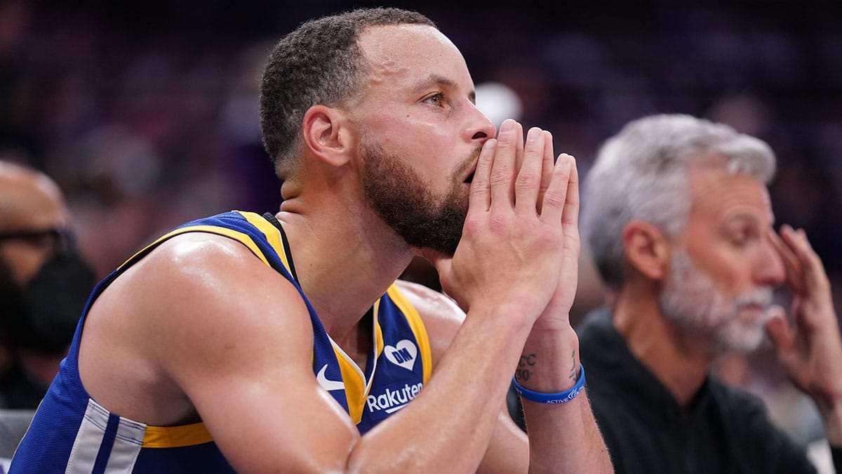 Golden State Warriors guard Stephen Curry (30) sits on the bench during action against the Sacramento Kings in the fourth quarter during a play-in game of the 2024 NBA playoffs at the Golden 1 Center. 