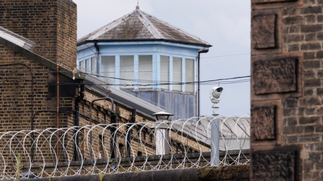 Article thumbnail: LONDON, ENGLAND - JULY 12: Security cameras at HMP Wandsworth prison on July 12, 2024 in London, England. The country's new justice secretary, Shabana Mahmood, announced today that the government will release thousands of prisoners early to alleviate overcrowding. Under the new policy, prisoners on "standard determinate sentences" will be released after serving 40% of their sentences, rather than 50%. (Photo by Dan Kitwood/Getty Images)