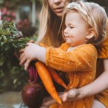 Article thumbnail: Family mother and child girl with organic vegetables healthy eating lifestyle vegan food homegrown carrot and beetroot local farming grocery shopping agriculture concept