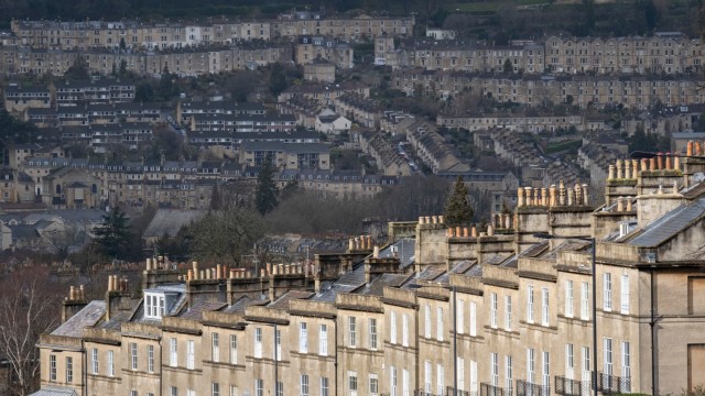 Article thumbnail: Seen from Bathwick Hill are foreground terraced homes at Dunsford Place on Bathwick Hill and in the distance, a cityscape of hillside properties around the city of Bath, on 19th February 2022, in Bath, England. The spa city of Bath was in the Roman period known as Aquae Sulis ("the waters of Sulis" c. 60 AD) and in 2019, its population was 101,106. (Photo by Richard Baker / In Pictures via Getty Images)