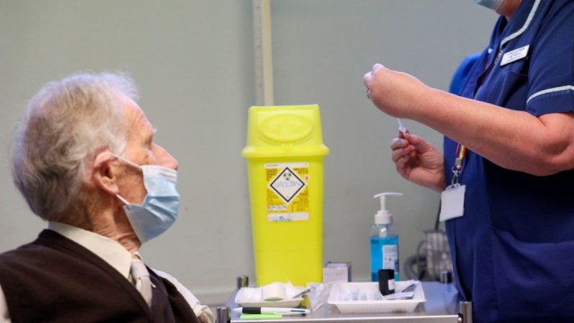 Article thumbnail: Patient Brian Horne receives a dose of the Pfizer-BioNtech COVID-19 vaccine from Lead Nurse Helen Ellis, at a GP led clinic in Chalfont St Peter, west of London, as hundreds of Covid-19 vaccination centres run by local doctors' surgeries begin opening across England. (Photo by Steve Parsons / POOL / AFP) (Photo by STEVE PARSONS/POOL/AFP via Getty Images)