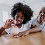 Article thumbnail: Child putting coin in piggy bank