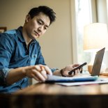 Article thumbnail: Man (early 30s) working in home office