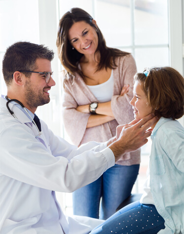 pediatric doctor examining little girl