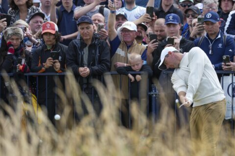 Thomas steadies himself in the wind and rain at Troon for early British Open lead