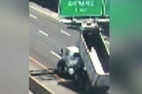 Hit and run: Dump truck damaged highway sign, showering debris across I-95 in Fairfax Co.