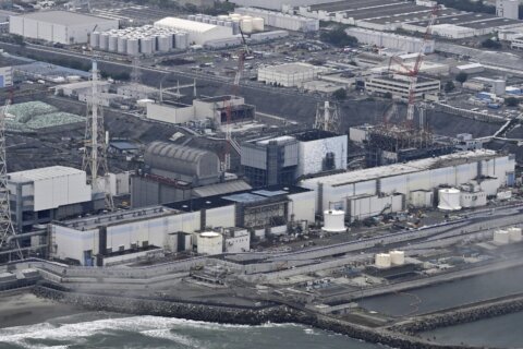 A robot begins removal of melted fuel from the Fukushima nuclear plant. It could take a century