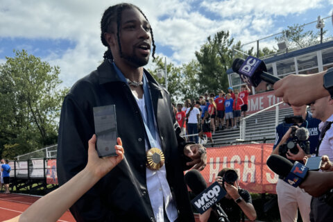 Olympic track star Noah Lyles saluted at his Alexandria high school