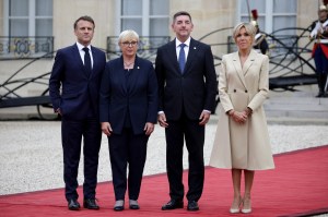 France's President Emmanuel Macron (L) and his wife Brigitte Macron (R) greet Slovenia's President Natasa Pirc Musar (2-L) and her husband Ales Musar (2-R) on arrival ahead of a reception for heads of state and governments ahead of the opening ceremony of the Paris 2024 Olympic Games, at the Elysee presidential palace in Paris, on July 26, 2024. (Photo by Valentine CHAPUIS / AFP) (Photo by VALENTINE CHAPUIS/AFP via Getty Images)