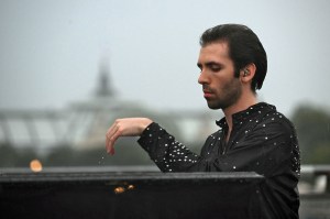 French pianist Alexandre Kantorow performs on the Passerelle Leopold-Sedar-Senghor along the river Seine