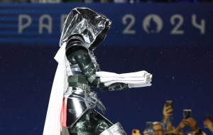 A woman carrying the Olympic flag is seen at the Trocadero during the Opening Ceremony of the Olympic Games Paris 2024