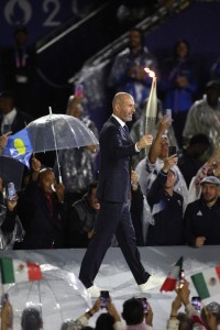 Zinedine Zidane, former French football player and manager, carries the Olympic Torch during the opening ceremony of the Olympic Games Paris 2024