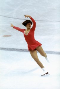 Dorothy Hamill skates on right skate with both arms posed above her head and left leg back during the Winter Olympics skating competition in 1976 in Innsbruck,  Austria. Dorothy Hamill wins the gold medel for the USA in the Womes Figure skating competition.