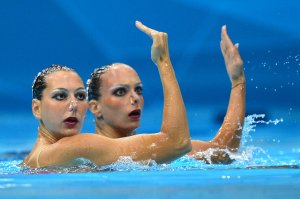 Italy's Mariangela Perrupato and Italy's Giulia Lapi  compete in the duets free routine preliminary round during the synchronised swimming competition at the London 2012 Olympic Games on August 6, 2012 in London.