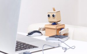 Cute little robot works on its laptop