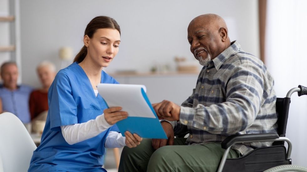 Medical professional with older man in a wheelchair