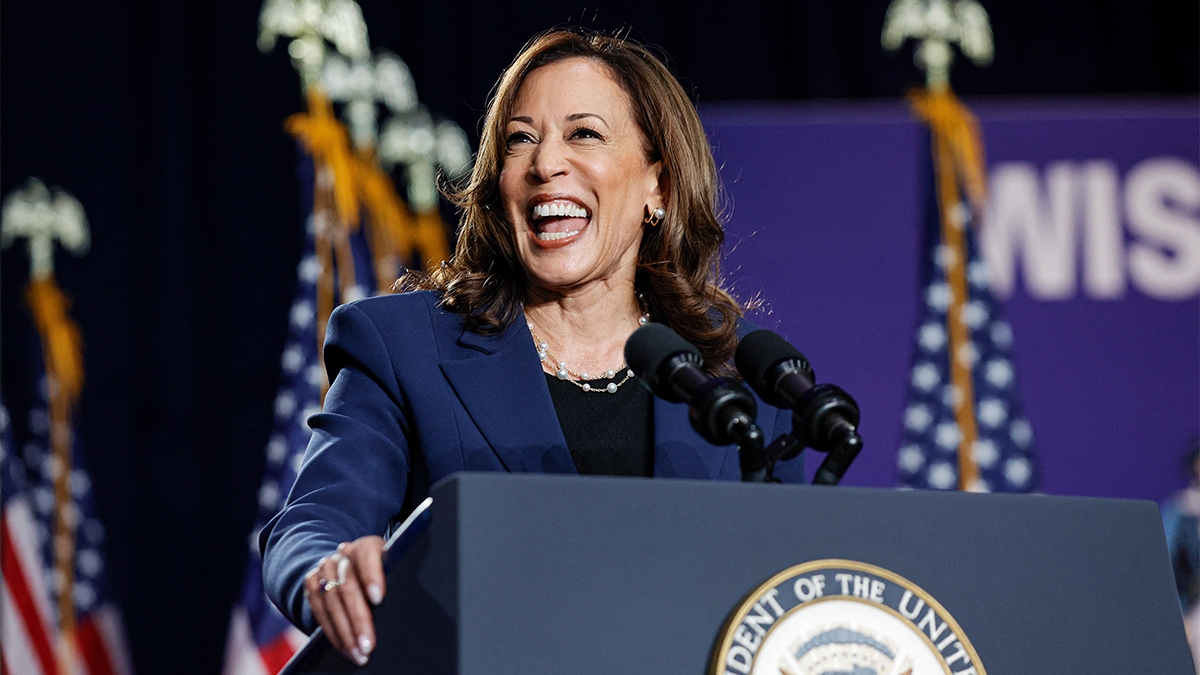 kamala harris smiling at a podium