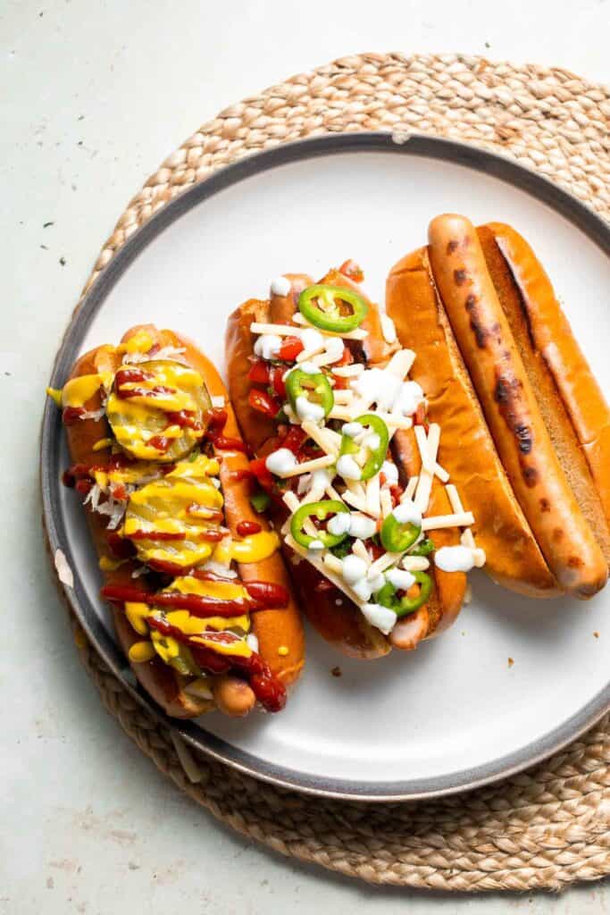 Juicy and delicious Gourmet Hot Dogs loaded with a variety of toppings will take your next backyard BBQ or potluck to a whole new level. Try them all! | aheadofthyme.com