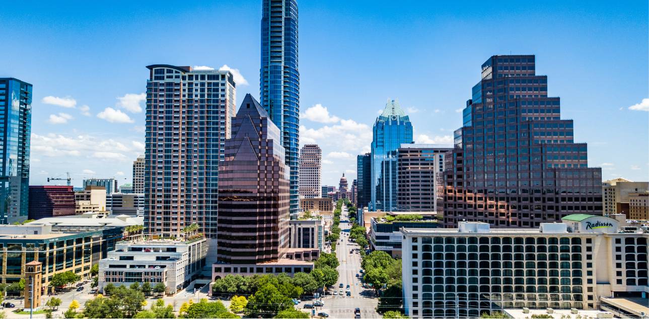 Looking down Congress Ave at buildings and capitol building in Austin, Tx