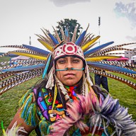 Native American man wearing feather headdress on Indigenous Peoples Day