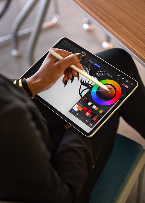 A close-up of an iPad Pro screen where Liza uses Procreate and Apple Pencil.