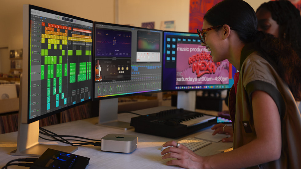 A Mac mini user sits at a desk with three displays and a musical keyboard.