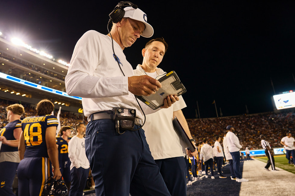 Coaches review footage on iPad during the game.