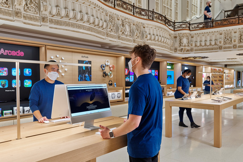 Apple Tower Theatre retail team members at iMac and iPad stations.