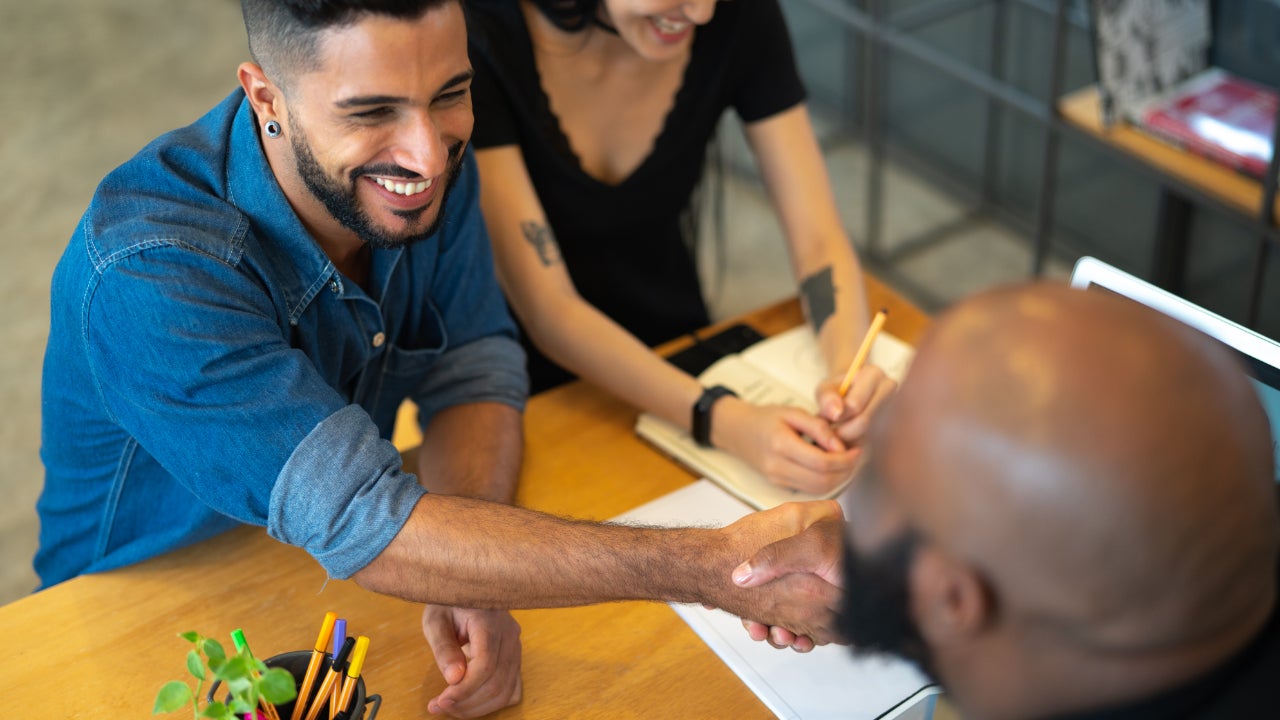 Couple shaking hands with an agent