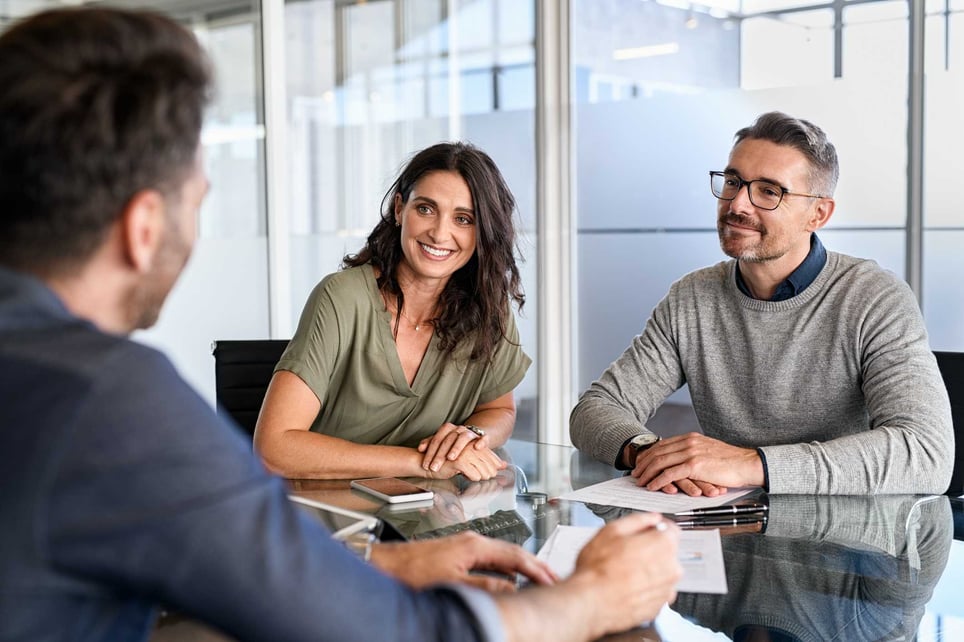 Two-coworkers-listening-to-a-man-being-interviewed-at-office-internal-interview-questions