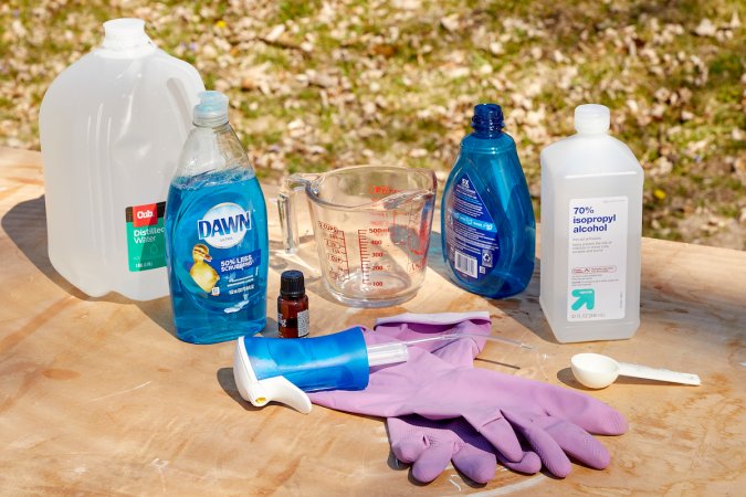 Ingredients to make DIY Dawn Powerwash, including dish soap, rubbing alcohol, and essential oils.